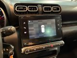 the dashboard of a car with a digital display in the center of it