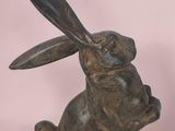 statue of a rabbit with a spoon in its mouth