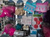 many bags of clothing on display in a store