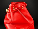 a red bucket bag on a black background