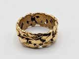 a close up of a gold ring on a white surface