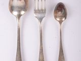 three spoons, a fork, and a spoon on a table