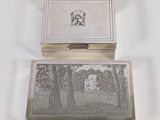 a silver box with a picture of a house on it