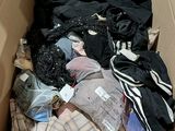 a cardboard box filled with clothes and other items