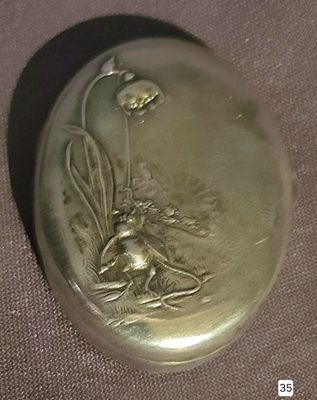 a gold locke with a picture of a bee on it