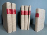 three books sitting on top of each other on a table