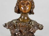 un petit buste en bronze représentant une femme avec un oiseau sur l'épaule