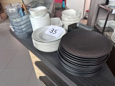 a lot of plates and bowls on the table