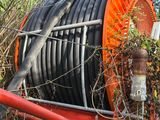 a large hose sitting on top of a pile of wires