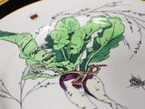 a plate with a drawing of a radish on it