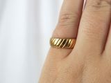 a woman ' s hand with a gold ring on it