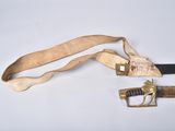 a knife and a belt on a white surface