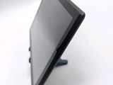 a tablet computer sitting on a stand on a white surface
