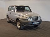 a picture of a silver suv parked in a garage
