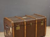 a brown trunk sitting on the floor in a room