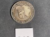 a small coin with a picture of a coat of arms on it