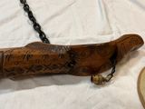 a wooden object with chains attached to it on a table