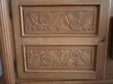 a close up of a wooden door with carvings on it