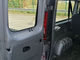 a grey van with its door open on the side of the road
