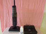 a vacuum that is sitting on a bed next to other items