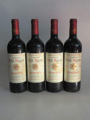 four bottles of red wine are lined up in a row