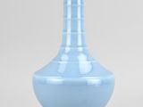 a blue vase that is sitting on a table
