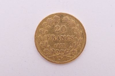 gros plan d'une pièce d'or sur une surface blanche