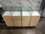 a group of three glass display cases sitting on top of a counter