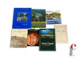 several books are sitting on a white surface next to each other