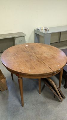 a wooden table with two chairs in a room