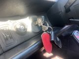 a red keychain sitting on the dashboard of a car