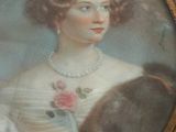 portrait of a woman with a dog in a gold frame