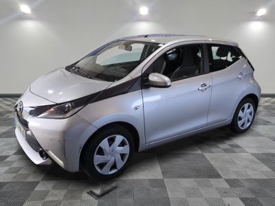 a picture of a silver toyota aygo parked on a checkered floor