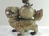 a statue of a turtle with a bird on it ' s back