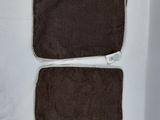 three pieces of brown cloth sitting on top of a white table
