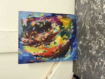 peinture représentant un tourbillon coloré sur un mur, à côté d'un autre mur