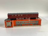 a red train car sitting on top of a box