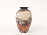 a vase with a painting on it on a white surface