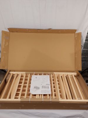a cardboard box with a wooden bed frame inside of it