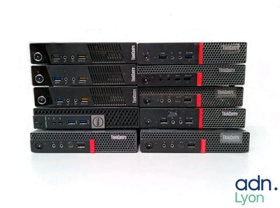 several black and red computers are stacked on top of each other