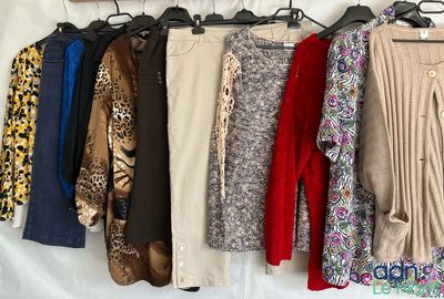 a lot of clothes that are hanging on a rack