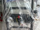 a machine that is wrapped in plastic and sitting on the ground
