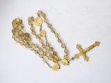rosary with cross and gold coins on a white background