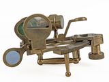 an old brass microscope on a stand with a magnifying lens