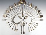 a lot of silver spoons and forks arranged in a circle