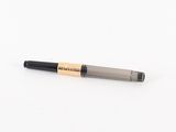 a pen that is laying on a white surface