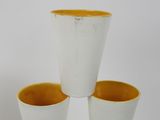 three cups sitting on top of each other on a table