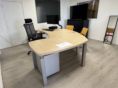 une photo d'une salle de réunion avec un bureau et des chaises