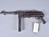 a close up of a gun with a tag attached to it