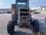 a tractor that is parked on the side of the road